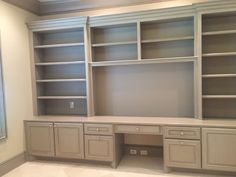 an empty room with built in cabinets and drawers