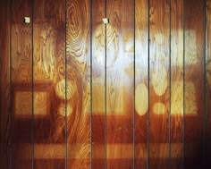 the wood paneled wall has three lights on it