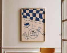 a painting hanging on the wall above a table with a cupcake and checkered flag