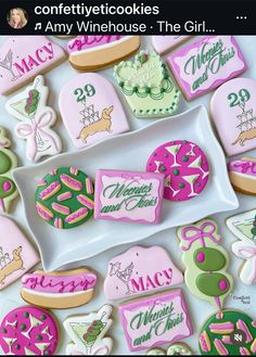 some decorated cookies are on a white plate