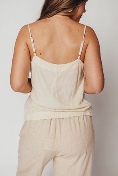 Whether you're on your way to sun-kissed beaches, picking up some things at the farmer's market, or stopping by your favorite coffee shop, you'll want to be wearing the Mello Tank. This is the easiest top we've curated this season -- it's breezy, chic, and completely feminine without any frills. Pair with denim, linen, or a slinky satin midi skirt. FIT: Runs true to size. MATERIAL: 55% Linen, 45% Rayon. GARMENT DETAILS: Lightweight camisole tank with square neckline, adjustable spaghetti straps, and relaxed fit. No lining. SIZE GUIDE: XS (0-2) / S (2-4) / M (6-8) / L (10-12) / XL (14-16) MODEL DETAILS: MISSES Mackenzie - Size S Heather - Size S Bust 34" 34" Waist 27.5" 27.5" Hips 40.5" 37.5" Height 5'7" 5'7" Chic Beach Season Camisole, Chic Cami Camisole For Beach Season, Chic Camisole For Beach Season, Summer Beachwear Camisole Tank Top, Summer Spaghetti Strap Tank Top For Vacation, Summer Spaghetti Straps Tank Top For Vacation, Chic Camisole For Beach Season Vacation, Chic Camisole For Beach Vacation, Unlined Cotton Tops For Summer