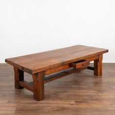 a wooden bench sitting on top of a hard wood floor