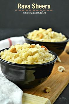 two black bowls filled with rice on top of a wooden cutting board