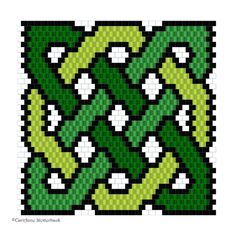 a cross stitch pattern with green and white squares