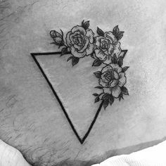 a black and white photo of a triangle with roses on the side by an artist