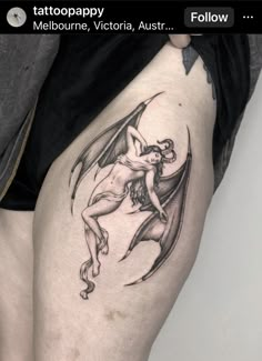 a tattoo on the thigh of a woman with a dragon in her lap and an arrow