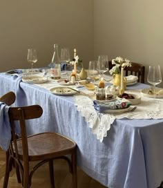 a dining table with plates and glasses on it