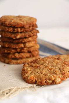 a stack of oatmeal cookies sitting on top of a white table cloth