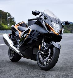 a black and gold motorcycle parked on the street