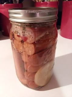 a jar filled with lots of food sitting on top of a table