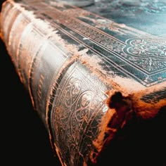 an old leather book with intricate designs on it