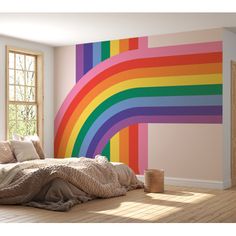 a bedroom with a rainbow painted on the wall