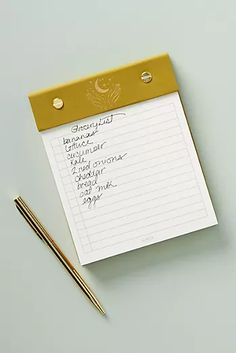 a notepad with writing on it next to a pen