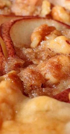 an apple pie with nuts and cinnamon toppings is shown in close up on a plate