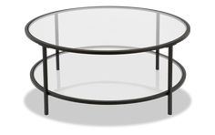 a round glass table with metal legs and a black frame around the top, on a white background