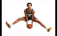 a basketball player is jumping in the air with his foot up and holding a ball