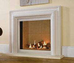 a teddy bear sitting in front of a fire place