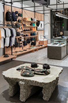 the inside of a clothing store with shoes on display