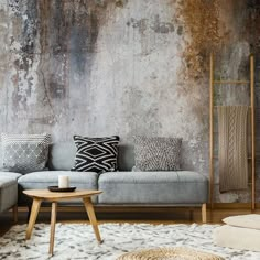 a living room filled with furniture and a wall covered in rusted metal foiling