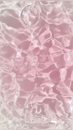 an abstract photo of water and bubbles in pink hued light blue, white and black