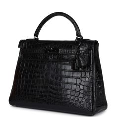 This So Black Kelly, in the Retourne style, is in Black Matte Niloticus Crocodile leather with PVD black hardware and features tonal stitching, front flap with two straps, front toggle closure, lock, clochette, two keys and single rolled handle.The interior is lined with Black chevre and has one zip pocket with an Hermès engraved zipper pull and two open pockets on the opposite sideCollection: N SquareOrigin: FranceCondition: Pre-owned; Excellent - This bag retains its shape structure. There is no plastic on the hardware. There are some hairline scratches to the exposed hardware and more visible scratches to the feet. The exterior leather has signs of wear with scratches to the croc skin on the front and back of back. The top handle is a little loose due to age and use. The interior has a Hermes Crocodile Bag, Hermes Kelly Retourne, Black Kelly, Kelly 32, Crocodile Bags, Hermes Box, Crocodile Leather, Black Hardware, Black Matte