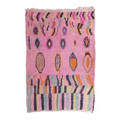 a pink rug with different colored designs on the front and back side, in various colors