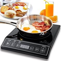 an electric stove with eggs, bacon and toast on it next to a plate of breakfast foods