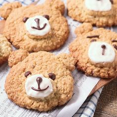 cookies with white frosting and teddy bears on top are arranged in a pattern, sitting on a napkin