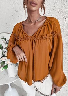 The EMES SHOP blouse is detailed with cute ruffle details. Features a tie neck. drop shoulder. solid color. and flowy fit. Pair it with palazzo pants and sunnies for a fantastic look.MATERIAL:100%Soft Poly MEASUREMENTS:Product Length 24"-26"in Small | Bust & Hem Width : 39"-41"in Medium| Bust & Hem Width : 41"-43"in Large| Bust & Hem Width : 43"-45"in X Large| Bust & Hem Width : 45"-47"in MEASUREMENTS:Product Length 60"-65"cm Small | Bust & Hem Width : 99"-104"cm Medium| Bust & Hem Width :104"-1 Solid Bohemian V-neck Blouse, Solid Long Sleeve Bohemian Top, Solid Bohemian Long Sleeve Top, Bohemian Long Sleeve Solid Tops, Bohemian Long Sleeve Top, Spring Beach Top In Solid Color, Bohemian Tops With Ruffle Sleeves For Day Out, Bohemian Ruffle Sleeve Tops For Day Out, Casual Bell Sleeve Blouse For Fall