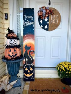 two pumpkins sitting on top of a planter in front of a door