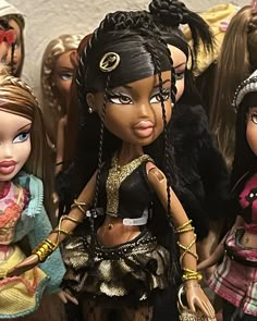 several dolls are lined up in a row, one is black and the other has blonde hair