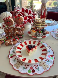 a table topped with cakes and desserts covered in frosting on top of plates