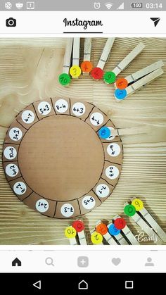 a wooden table topped with lots of different colored pins and numbers on top of it