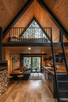 a loft with wood floors and stairs leading to the upper floor, along with an open kitchen area