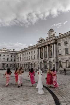 Bride in modern wedding dress with open back detail and long veil walking with bridal party wearing mismatched pink bridesmaid dresses at Somerset House City Wedding Bridesmaid Dresses, City Wedding Bridesmaids, Pink Bridesmaids Dresses Mismatched, Mismatched Pink Bridesmaid Dresses, Pink Bride Dress, Bridesmaids In Pink, Groom And Groomsmen Outfits