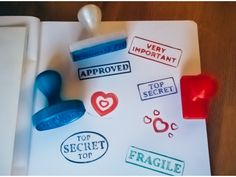 stampers and rubber stamps on top of a piece of paper with the words approved, top secret, fragile, very important