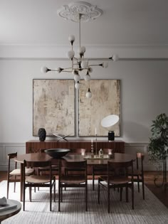 a dining room table with six chairs and a large painting on the wall behind it