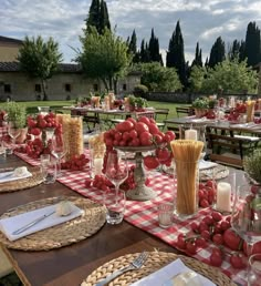 an outdoor dining area with red and white checkered table cloth, wicker baskets, silverware