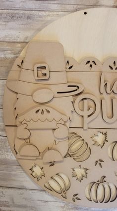 a wooden cutout with the words happy pum and pumpkins on it, surrounded by fall leaves