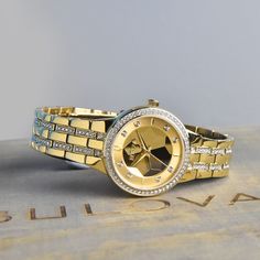 Showcasing a champagne dial adorned with pave crystals and set in a 32mm gold-tone stainless steel case, this beautiful women's watch from the Crystals collection by Bulova positively shines. 32mm gold-tone stainless steel case Champagne dial The gold-tone, crystal embellished link bracelet secures with a push-button fold-over clasp. Water-resistant Crystals Collection, Jared The Galleria Of Jewelry, Womens Watches Luxury, The Crystals, Crystal Collection, Women's Watch, Push Button, Stainless Steel Case, How To Take Photos