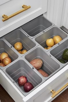 an organized drawer in the kitchen with potatoes, onions and avocados inside it