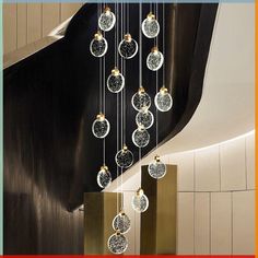 a group of glass balls hanging from the side of a stair case in a building