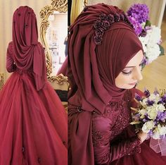 a woman in a red dress with flowers on her head and wearing a hijab