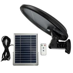 a solar powered light and remote control on a white background