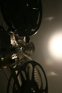 an old movie projector with the sun in the background