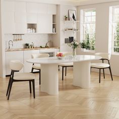 a dining room table with four chairs around it