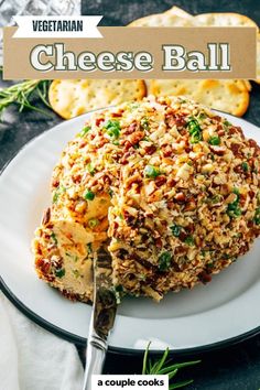 a cheese ball on a plate with crackers and bread in the background text reads vegetarian cheese ball