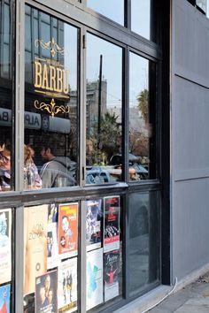 a store front with many posters in the window