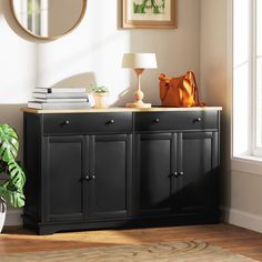 a black cabinet with books and a lamp on top