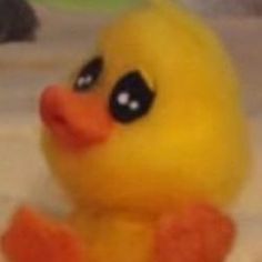 a yellow rubber duck sitting on top of a bed